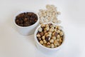 Dry fruits isolated in white pots