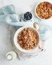 Dry granola in bowl. Breakfast, healthy diet food with milk in bottle, oat flakes Royalty Free Stock Photo