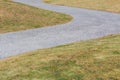 Dry grass field with curved walkway road. Royalty Free Stock Photo