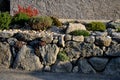 Dry gray wall, folded boulders without the use of cement. the art of folded retaining walls. very colorful rock gardens like the r Royalty Free Stock Photo