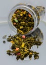 Dry Green Floral Tea Pouring from Jar. Transparent can with black and green tea. Royalty Free Stock Photo