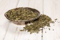 Dry green tea on grey wood Royalty Free Stock Photo