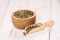 Dry green tea on grey wood Royalty Free Stock Photo