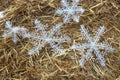 Rolled straw decorated with white snow crystals at rural animal farm as a christmas background Royalty Free Stock Photo