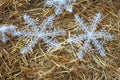 Rolled straw decorated with white snow crystals at rural animal farm as a christmas background Royalty Free Stock Photo