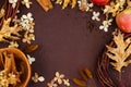 Dry hydrangea flowers, autumn leaves, cinnamon, herbs on brown background. Top view. Decor element with copy space for holiday Royalty Free Stock Photo