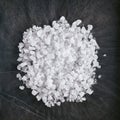 Dry Ice Crystals or Solid Carbon Dioxide on Natural Black Stone Background