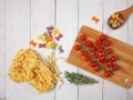 Dry Italian pasta fettuccini and farfalle with tomatoes and rosemary Royalty Free Stock Photo