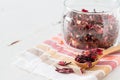 Dry karkade tea, white wood background Royalty Free Stock Photo