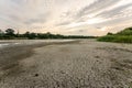 Drought and climate change, landscape of cracked earth with orange sky after lake has dried up in summer. Water crisis an impact Royalty Free Stock Photo