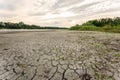 Drought and climate change, landscape of cracked earth with orange sky after lake has dried up in summer. Water crisis an impact Royalty Free Stock Photo