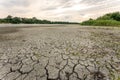 Drought and climate change, landscape of cracked earth with orange sky after lake has dried up in summer. Water crisis an impact Royalty Free Stock Photo