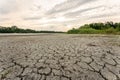 Drought and climate change, landscape of cracked earth with orange sky after lake has dried up in summer. Water crisis an impact Royalty Free Stock Photo