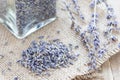 Dry lavender tea in jag and on wooden background, horizontal