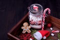 Dry layered mix to prepare hot chocolate in a glass mason jar surrounded by Christmas attributes