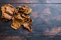 Dry leafs tobacco Nicotiana tabacum and tobacco leaves on old wood planks table dark top view space for text Royalty Free Stock Photo