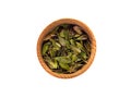 Dry leaves of Arctostaphylos in a wooden Cup on a white background