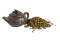 Dry leaves of tea tieguanyin, scattered around a porcelain teapot, a tea blade.