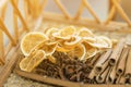 Dry lemon and some Chinese herb on wooden plate,soft focus