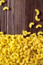 Dry Macaroni Pasta Texture Background. Traditional Italian Gourmet Cuisine iNgredients on Wood Table Royalty Free Stock Photo