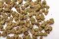 Dry marijuana buds, cannabis dried flowers, medical marijuana, laying on the white table