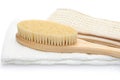 A dry massage brush, a washcloth made of natural materials and a cotton towel on a white background. Cleanliness and body care