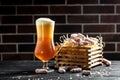Dry Mini salami sticks with cold craft light beer in a glass with water drops. Dried snacks for beer Royalty Free Stock Photo