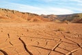 The landscape of dry mountains and mud cracked pattern on desert ground