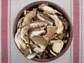 Dry mushrooms Boletus edulis on the table, top view. Gourmet dishes of porcini mushrooms
