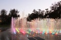 Dry musical fountain with a multi-colored pendant in the evening. Organization of recreation in the urban landscape. Park area Royalty Free Stock Photo