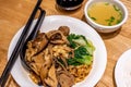 Dry noodles with assorted mushrooms served with soup - Traditional Food photography