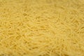Dry noodles texture, yellow pasta background, small pasta vermicelli or macaroni, Traditional Italian food Royalty Free Stock Photo