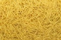 Dry noodles texture, yellow pasta background, small pasta vermicelli or macaroni, Traditional Italian food Royalty Free Stock Photo