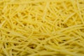 Dry noodles texture, yellow pasta background, small pasta vermicelli or macaroni, Traditional Italian food Royalty Free Stock Photo