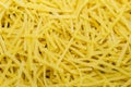 Dry noodles texture, yellow pasta background, small pasta vermicelli or macaroni, Traditional Italian food Royalty Free Stock Photo