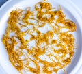 Dry orange zest on a white plate. Dry citrus zest, grated orange peel Royalty Free Stock Photo
