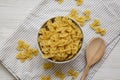 Dry Organic Farfalle Pasta in a Bowl on a white wooden background, top view. Flat lay, overhead, from above Royalty Free Stock Photo