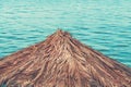 Dry palm leaf beach parasol for sun protection at seaside during summer holiday