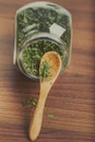 Dry parsley in glass jar with wooden spoon Royalty Free Stock Photo