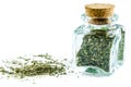 Dry parsley herb in glass bottle and heap of parsley near it. Royalty Free Stock Photo