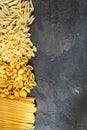 Dry pasta background. Different pasta on dark background. Flat l Royalty Free Stock Photo