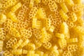 Dry pasta in the form of a wheat ear close-up. Culinary background, texture, pattern of yellow macaroni. Copy space. Grain product Royalty Free Stock Photo