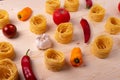 Dry pasta rolls and ingredients for making a tomato sauce Royalty Free Stock Photo