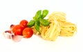 Dry pasta with tomatoes, basil and garlic. Royalty Free Stock Photo