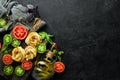 Dry pasta, tomatoes, greens, oil and ingredients. Italian traditional cuisine. Fresh vegetables. Top view. Royalty Free Stock Photo