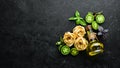 Dry pasta, tomatoes, greens, oil and ingredients. Italian traditional cuisine. Fresh vegetables. Top view. Royalty Free Stock Photo