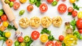 Dry pasta, tomatoes, greens, oil and ingredients. Italian traditional cuisine. Fresh vegetables. Top view. Royalty Free Stock Photo