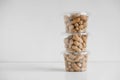 Dry peanuts in a transparent plastic bowls on a white background. Copy, empty space for text Royalty Free Stock Photo