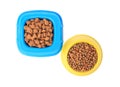 Dry pet food in feeding bowls isolated on white, top view Royalty Free Stock Photo