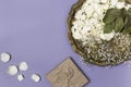 Dry petals of white roses and gypsophila on a beautiful antique tray, a gift wrapped in craft paper on a blue background. Place